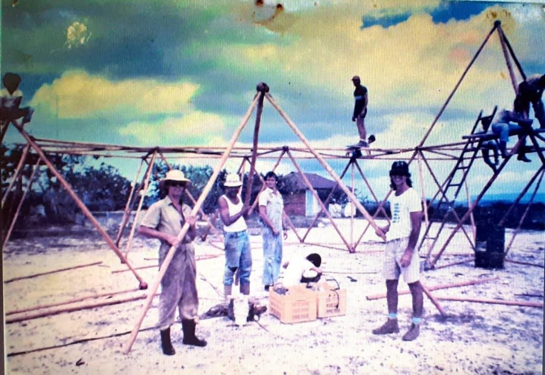 A crew raising a bamboo geodesic frame