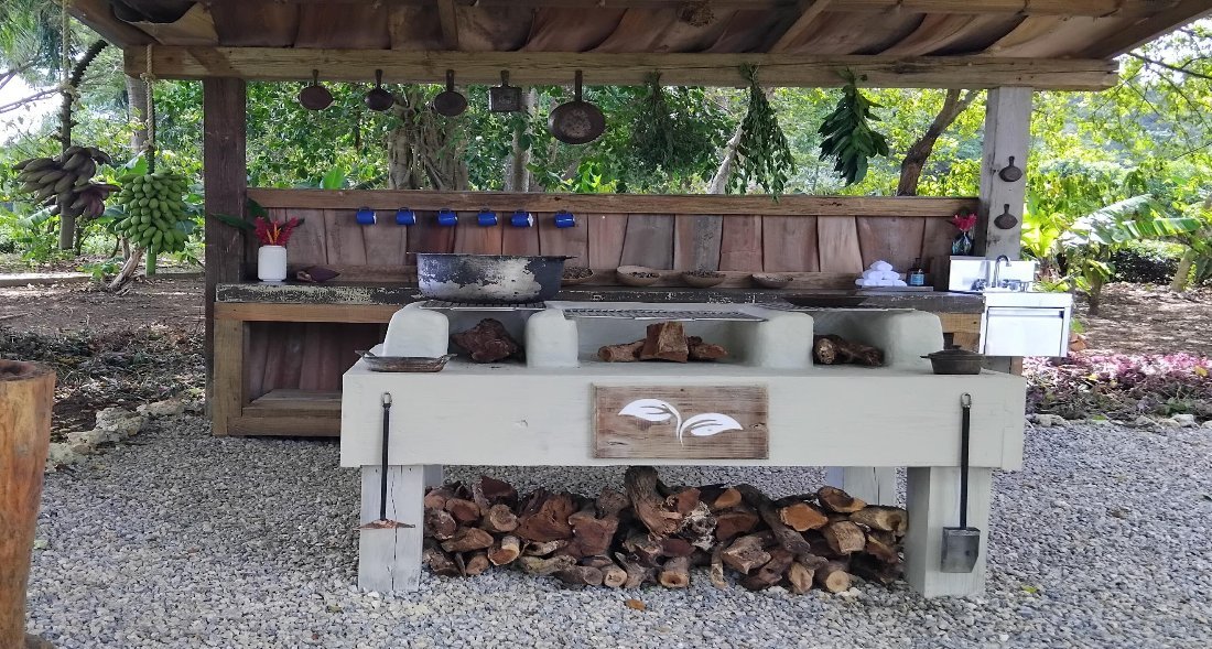 An outdoor kitchen under a timber roof