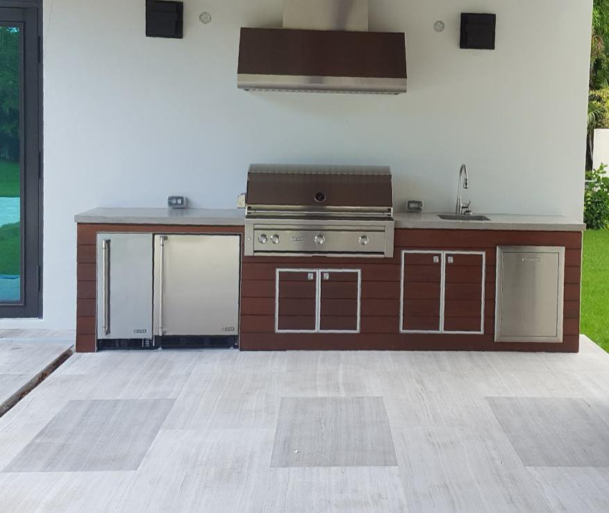 An indoor kitchen with hardwood fronts